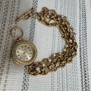Gold and Cream Pocket Watch with Intricate Chain